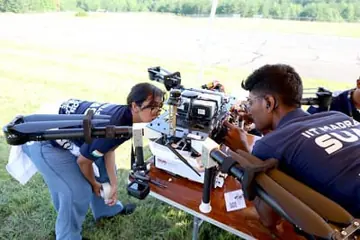 Team members inspecting the 2025 UAV before a competition flight