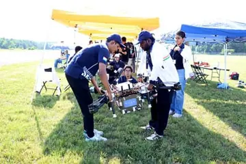 SUAS IITM members carrying the 2025 UAV onto the flight field