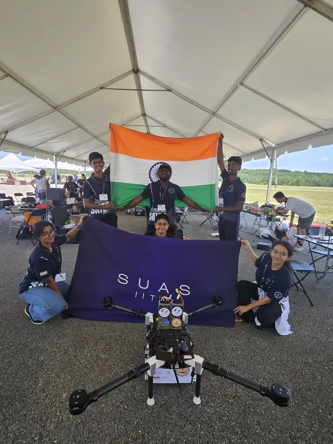 The team with the SUAS IITM banner and the 2025 UAV at the competition